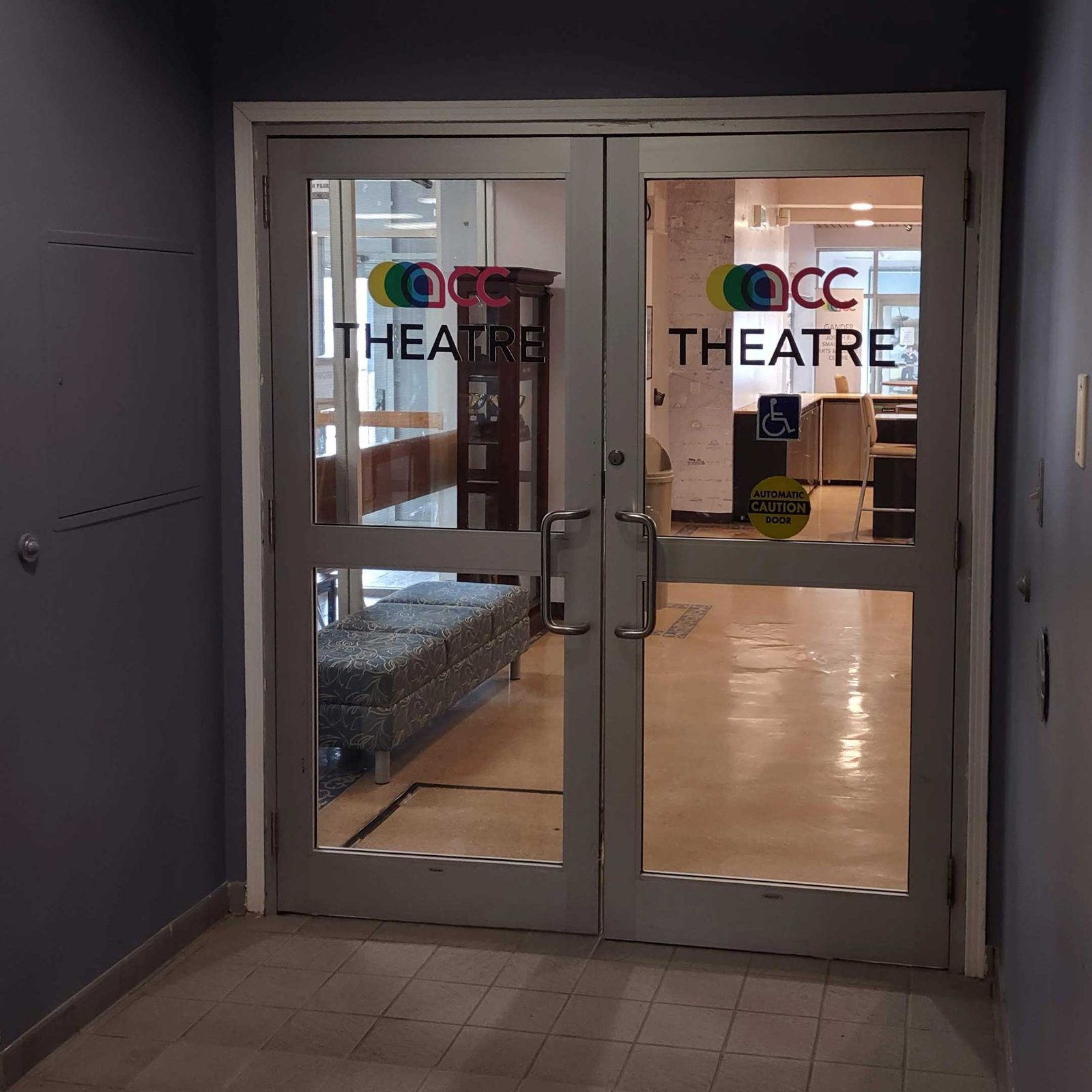 The glass doors from the second intersection. They now have large decals announcing the entrance to the theatre.