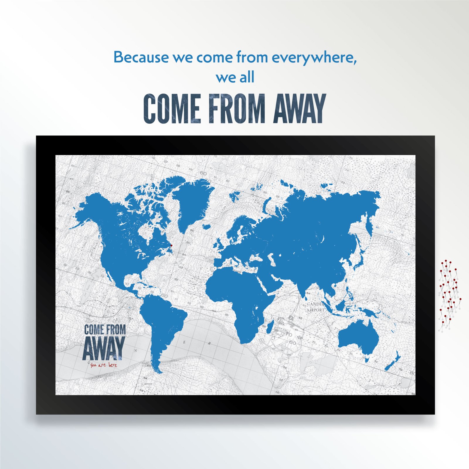 Image of the Come From Away pinboard map. A map of the world that visitors can stick pins in. It reads. Because we come from everywhere, we all Come From Away.