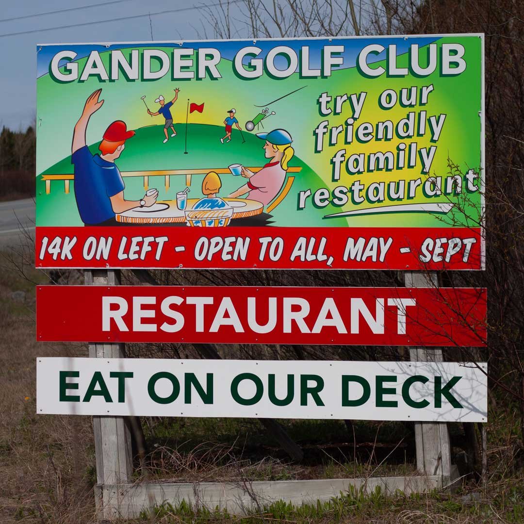 Gander Golf Club  highway sign. It reads, Gander Golf Club, Open to all, restaurant, eat on our deck.